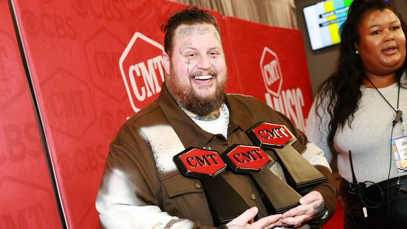 Singer Jelly Roll holding three CMT Music Awards.